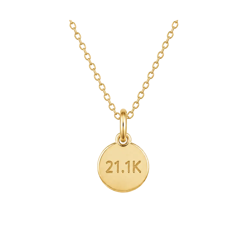 Gold necklace with a round pendant displaying '21.1K' on a white background
