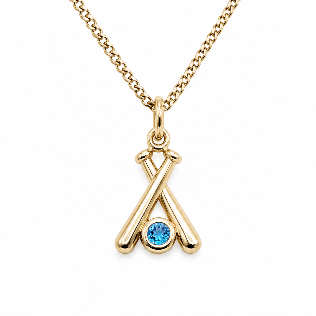 Gold necklace with a blue gemstone pendant on a white background