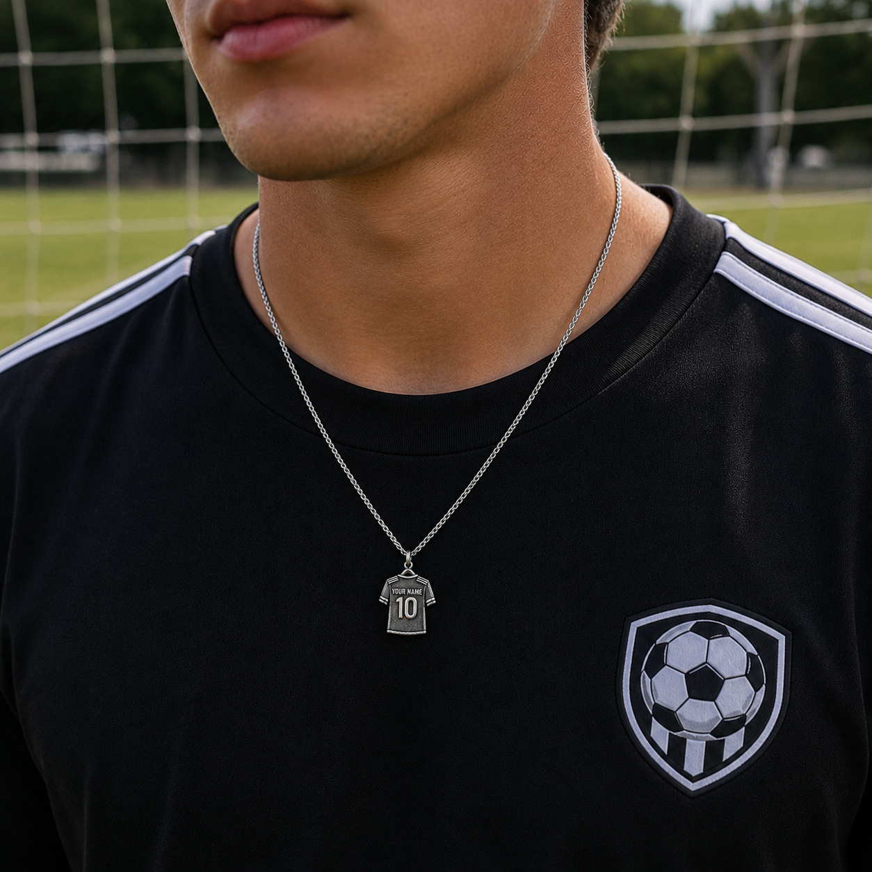 Person wearing a black sports jersey with a soccer-themed necklace featuring a number 10 pendant.